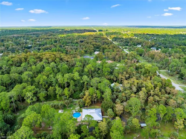 View of property location with a heavily wooded area