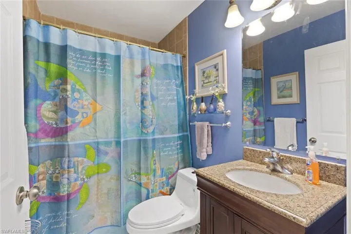 Bathroom featuring vanity and curtained shower