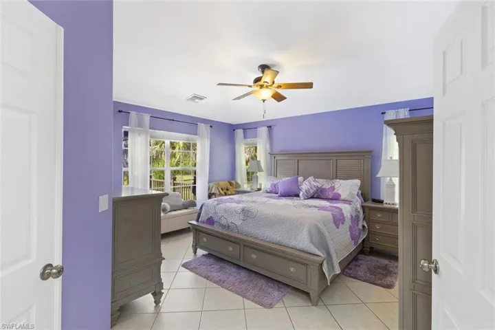 Bedroom with light tile patterned flooring and ceiling fan