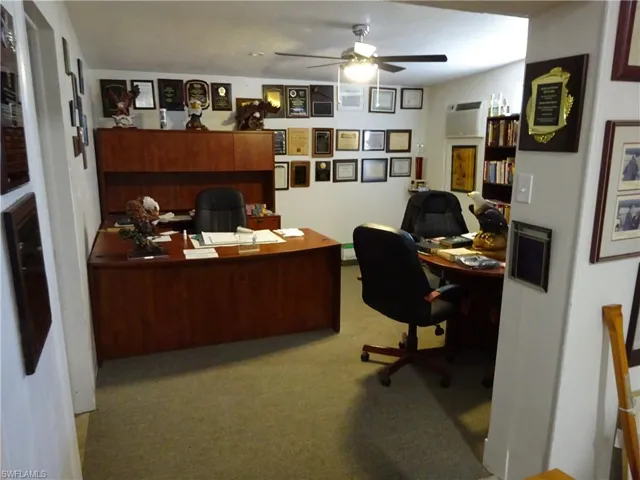 Office featuring a ceiling fan and light colored carpet