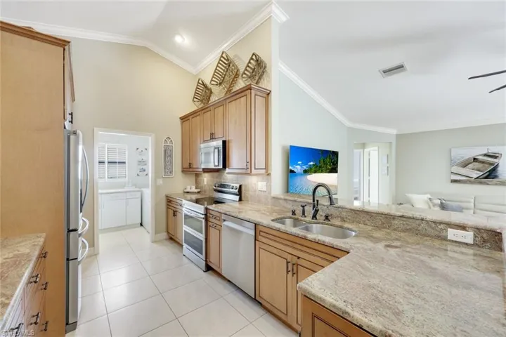 Kitchen with pocket door to the adjoining laundry room