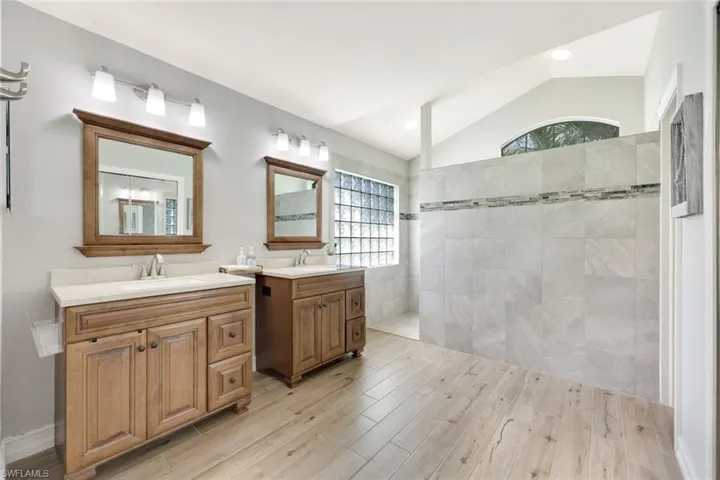 Master bath with dual sinks, step-in shower and walk-in closet