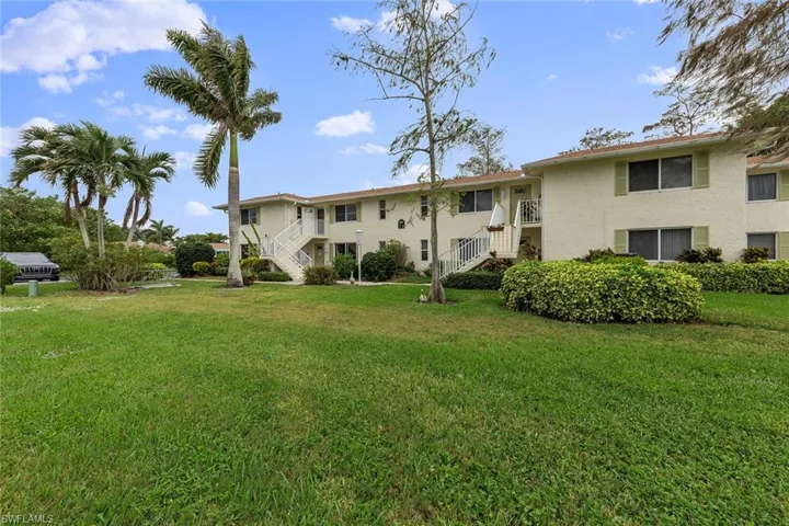 Rear view of house featuring a lawn