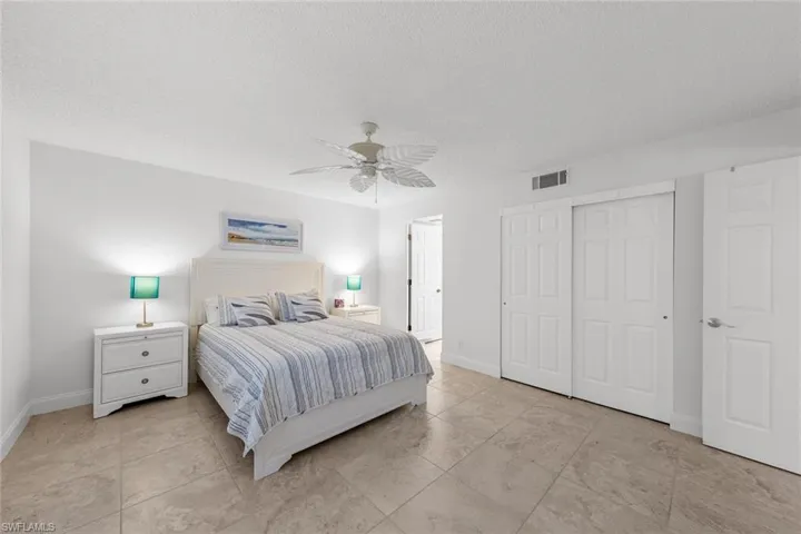 Bedroom featuring ceiling fan, a closet, and a textured ceiling