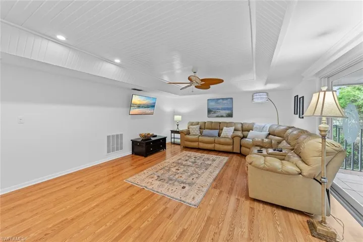 Living room featuring ceiling fan and light wood-type flooring