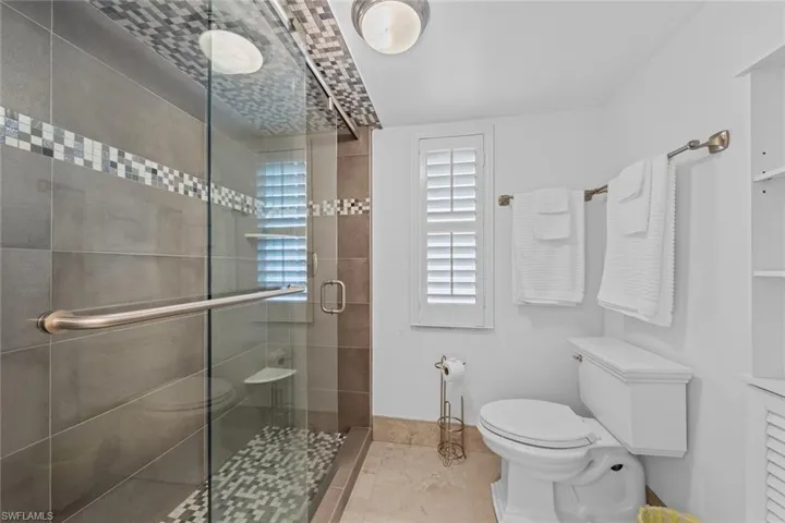 Bathroom with toilet and an enclosed shower