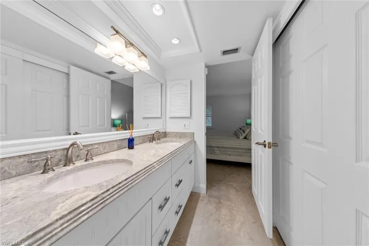 Bathroom featuring vanity, tile patterned floors, and ornamental molding