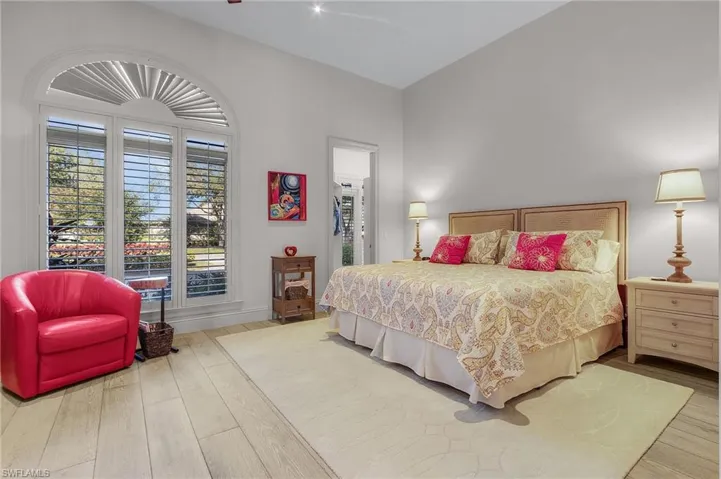 Bedroom featuring hardwood / wood-style flooring and lofted ceiling