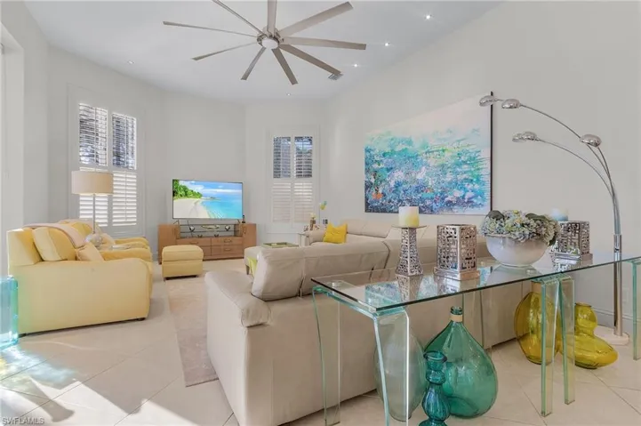 Tiled living room featuring ceiling fan