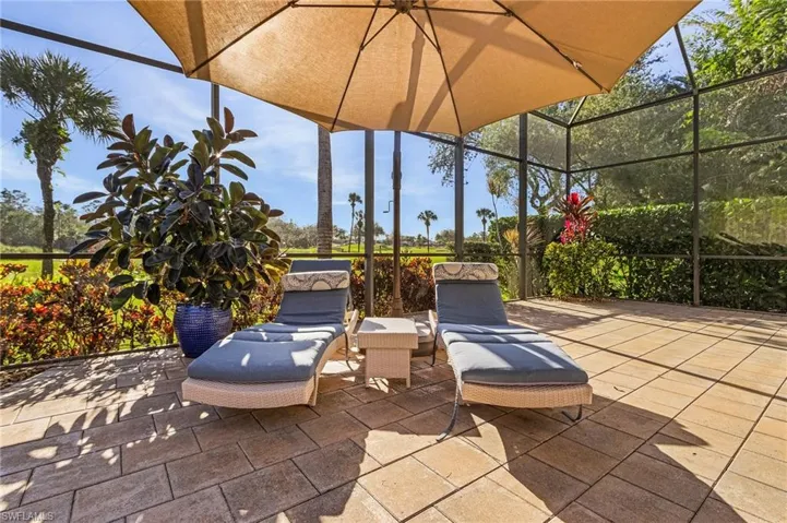View of patio featuring a lanai