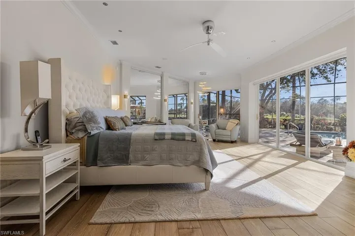 Bedroom with ceiling fan, crown molding, access to outside, and hardwood / wood-style flooring