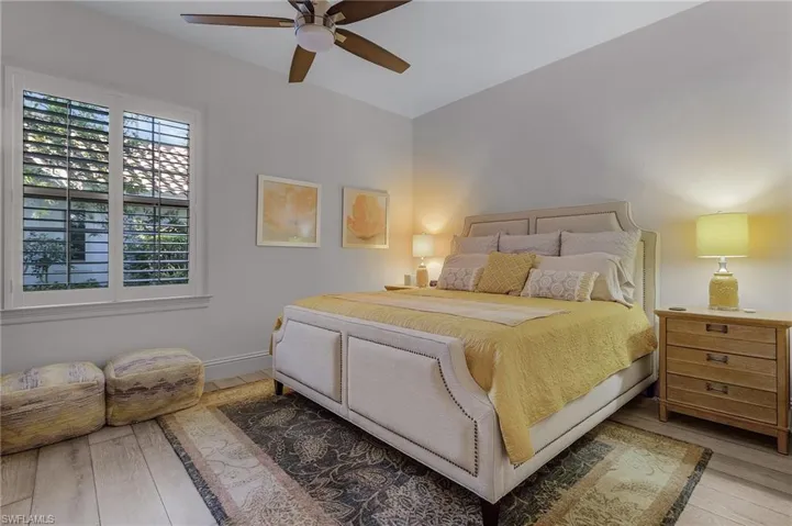 Bedroom featuring hardwood / wood-style floors and ceiling fan