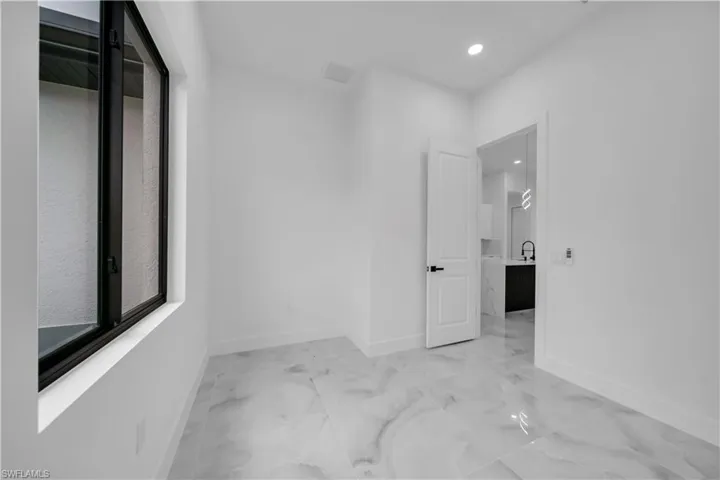 Unfurnished room with recessed lighting and light marble finish flooring