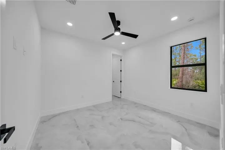 Unfurnished room featuring recessed lighting, ceiling fan, and light marble finish flooring