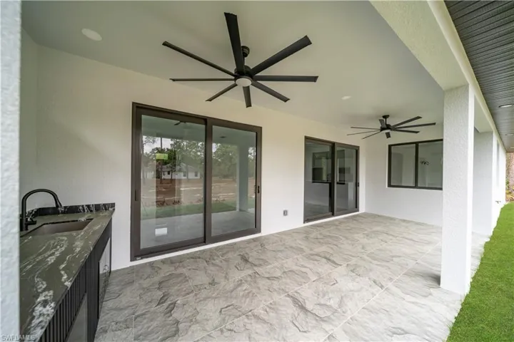 View of patio / terrace featuring ceiling fan and a sink