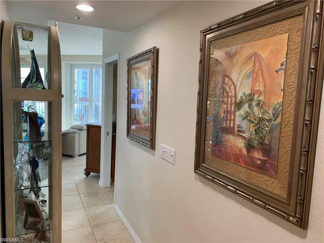 Hallway featuring light tile patterned floors and recessed lighting