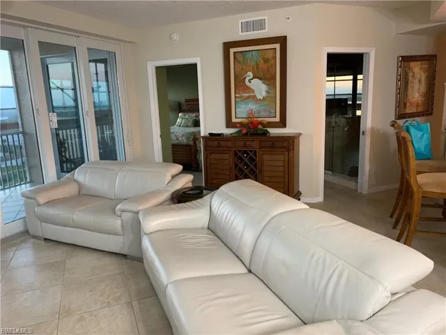 Living room featuring tile patterned floors and a textured ceiling