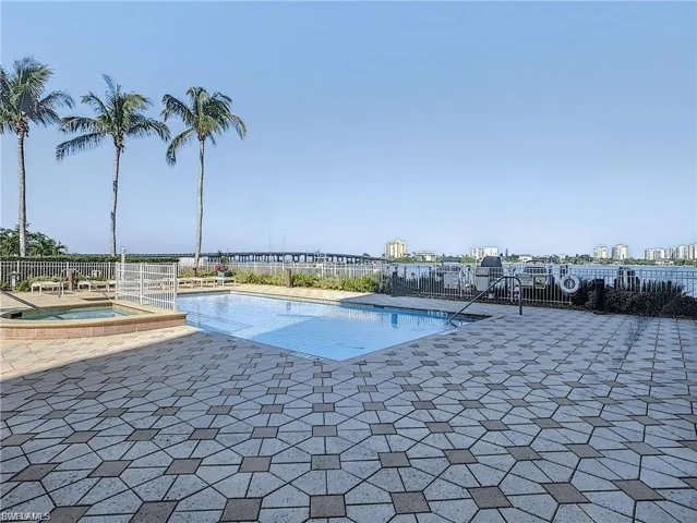View of swimming pool featuring a patio and a pool with connected hot tub