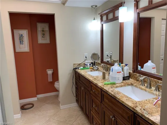 Bathroom featuring double vanity and light tile patterned floors