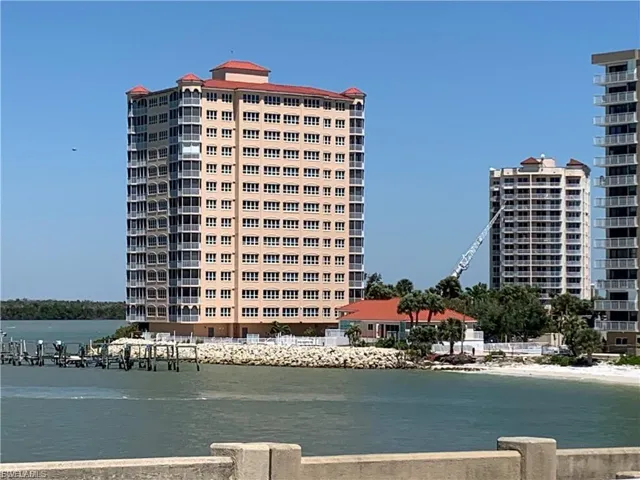 View of apartment building / complex featuring a water view