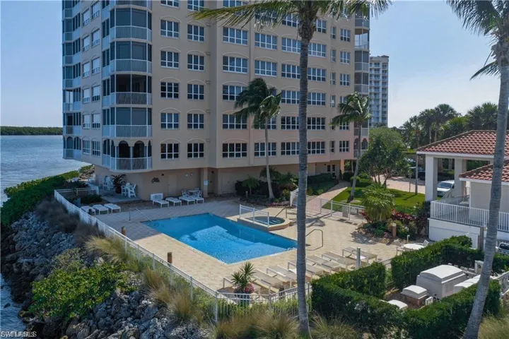 Community pool with a patio, a gazebo, and a water view