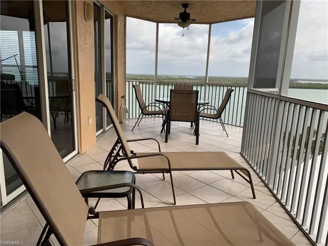 Sunroom featuring floor to ceiling windows, tile patterned flooring, and plenty of natural light