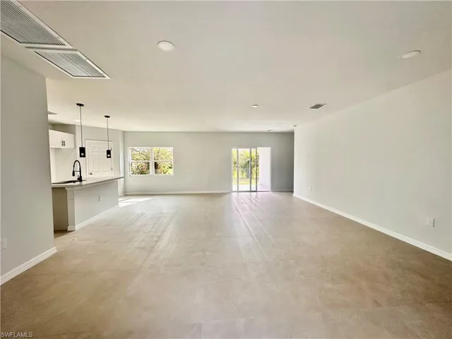 Living room with recessed lighting,  baseboards, and a sink