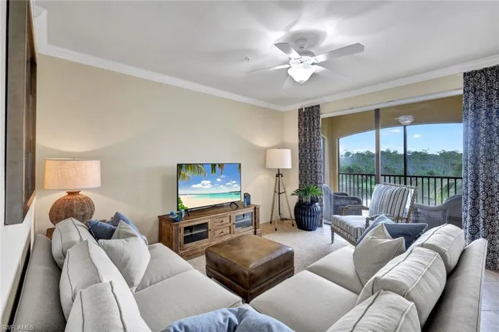Living area with ornamental molding and ceiling fan