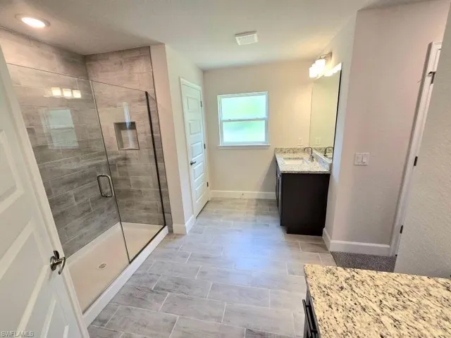 Bathroom featuring vanity, a Tiled 5FT shower, Linen Closet & Water Closet