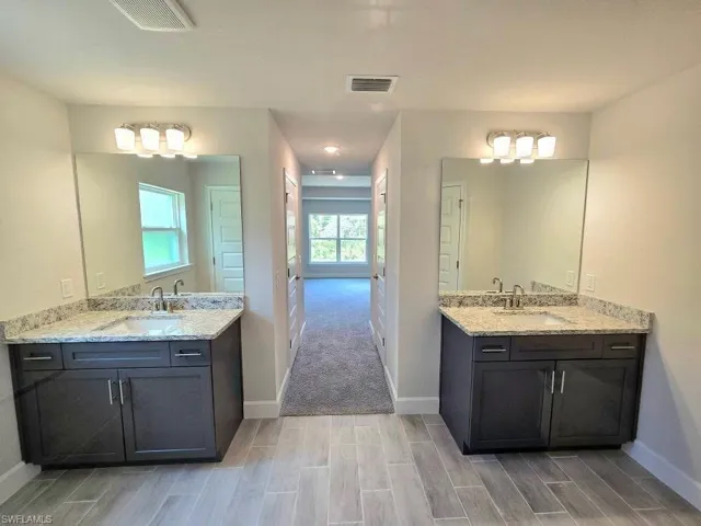 Bathroom featuring wood tiled floors and Dual sinks/vanities