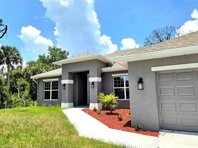 Property entrance with stucco siding and a garage