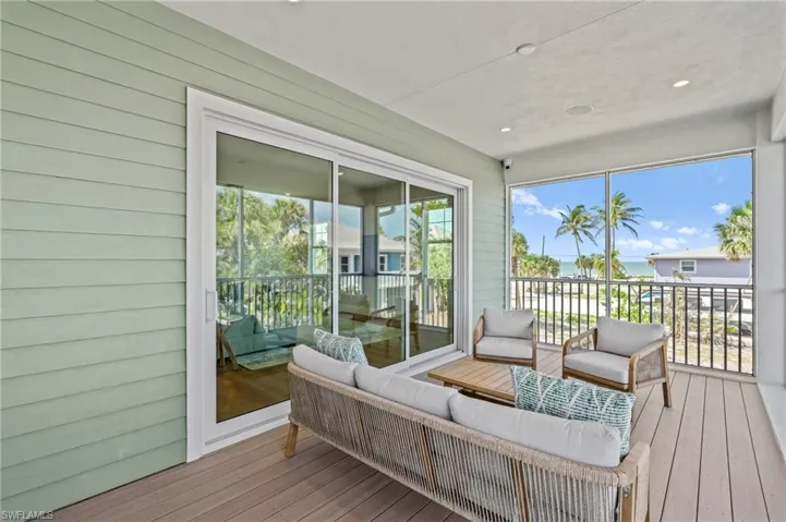 Spacious balcony featuring an outdoor sitting area. virtually edited photo