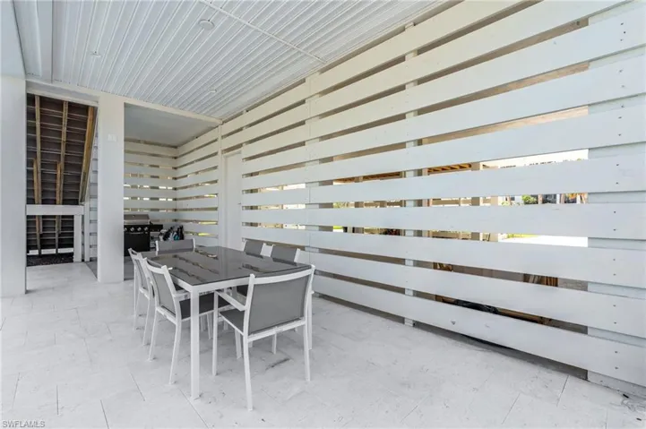 View of patio featuring outdoor dining area. virtually edited photo