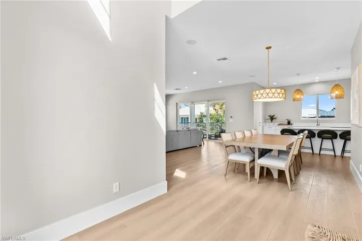 Dining area featuring recessed lighting, light wood-type flooring, visible vents, and baseboards. virtually edited photo