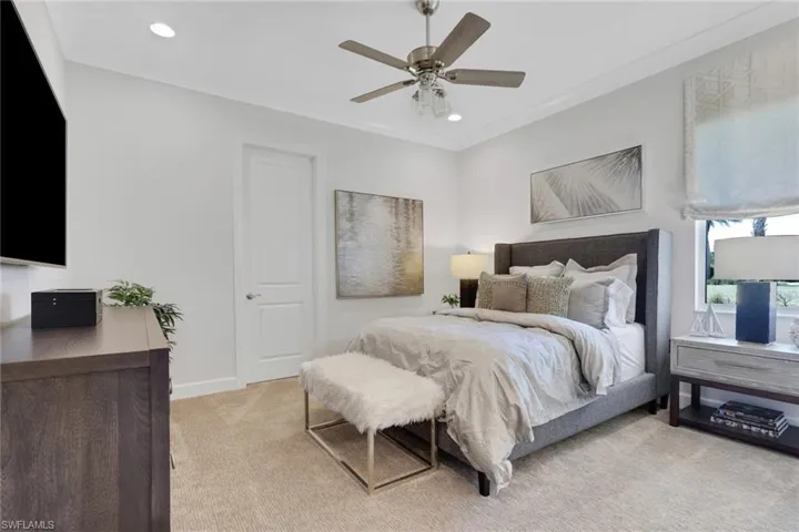 Bedroom with light colored carpet, a ceiling fan, ornamental molding, and recessed lighting