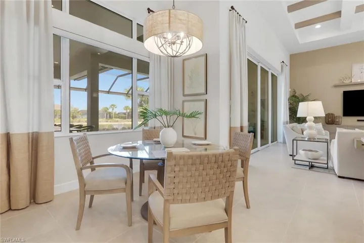 Dining space with a chandelier and a high ceiling