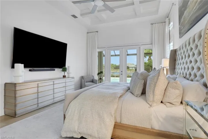 Bedroom featuring french doors, coffered ceiling, access to outside, and ceiling fan