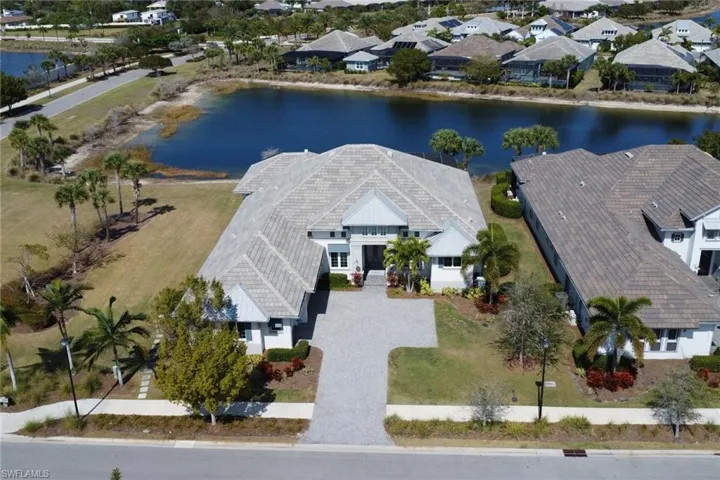 Aerial view of residential area featuring a nearby body of water