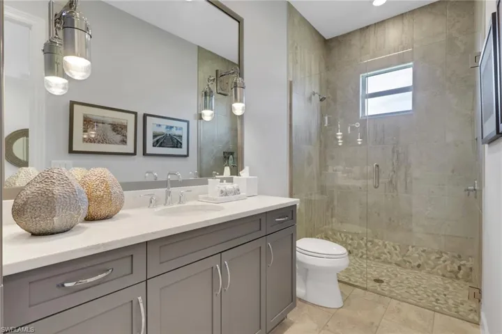 Bathroom featuring vanity and a stall shower