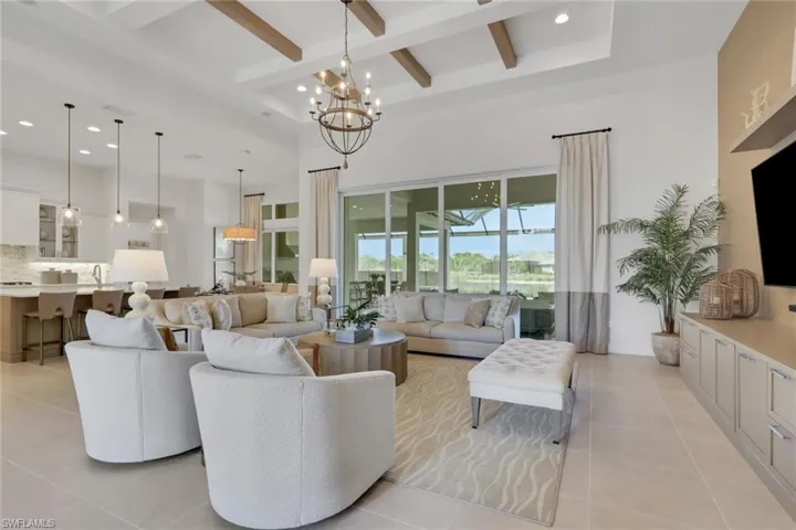 Living room featuring hanging lights and light tile patterned flooring