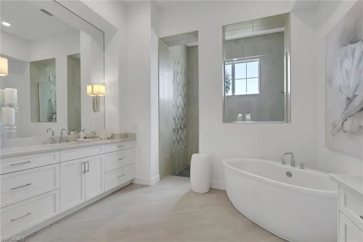 Bathroom with vanity, a walk in shower, and a soaking tub