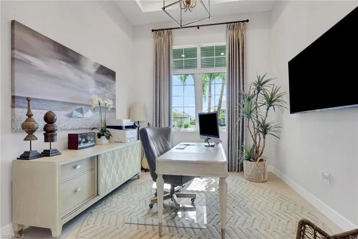 Office area with baseboards and suspended lighting