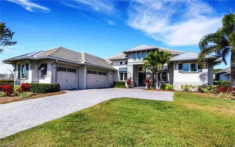 Prairie-style home with stucco siding, decorative driveway, an attached garage, and a front yard