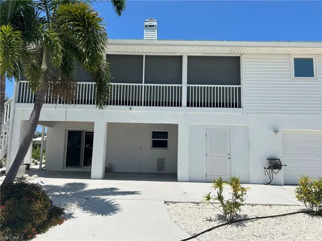 View of rear of house with a garage door