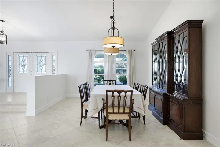 Dining space featuring baseboards and vaulted ceiling