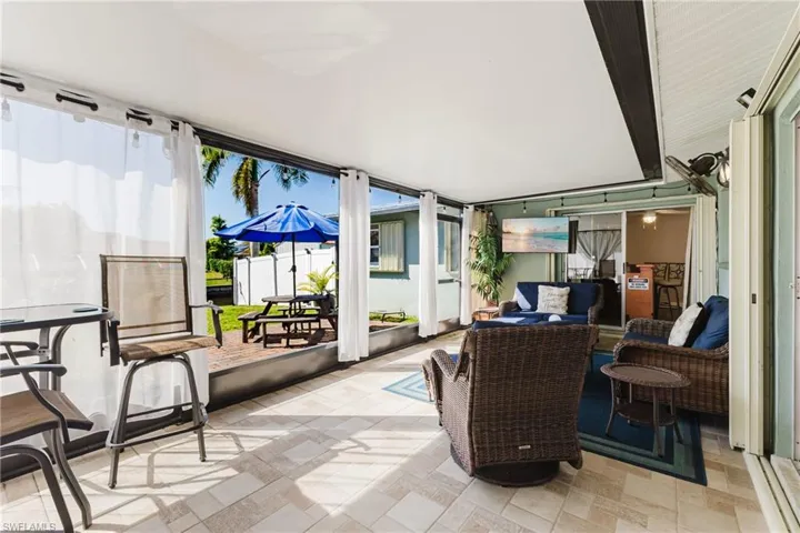 Sunroom with outdoor furniture, plenty of natural light, and a patio area