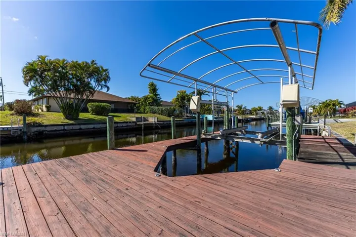 Dock area with boat lift and a water view