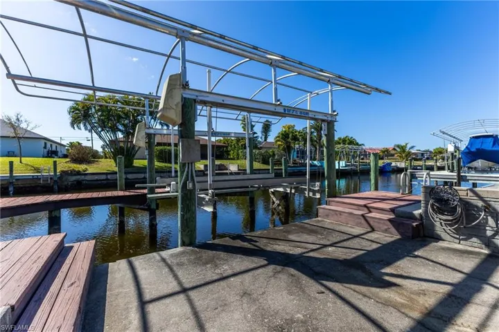 Dock area with boat lift and a water view