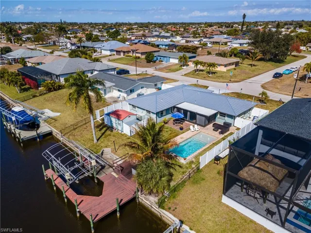 Aerial perspective of suburban area with a nearby body of water