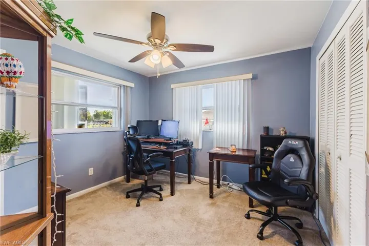 Office space featuring light carpet and ceiling fan